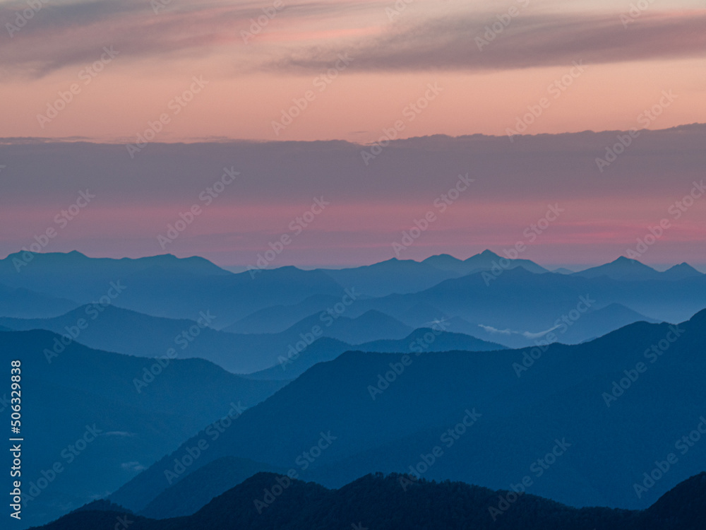 Sunrise over mountain ranges silhouette from mountain top sunset