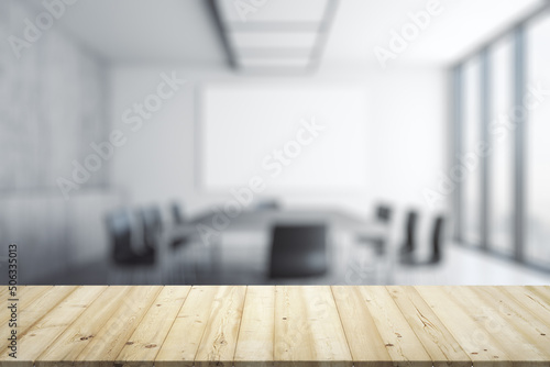Empty office wooden table with empty space on modern conference room with large window background, closeup, mockup © Pixels Hunter