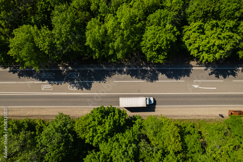 Road through the green forest, aerial view car drive going through forest, top down view forest, view from above, ecosystem and healthy environment concept and background.