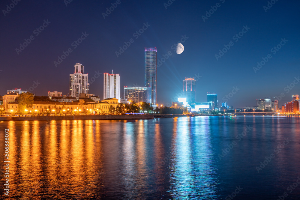 Night with big moon on a pond in the center of the city. Yekaterinburg city and pond at night. Night with big moon on a pond in the center of the city. Yekaterinburg city and pond at night.