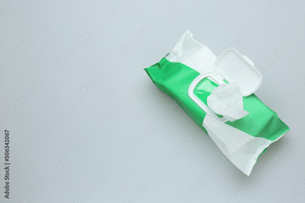 Wet wipes flow pack on light background, top view. Space for text Wet wipes flow pack on light background, top view. Space for text