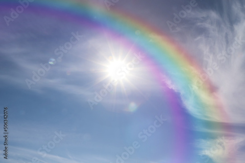 Beautiful view of bright rainbow in blue sky on sunny day © New Africa