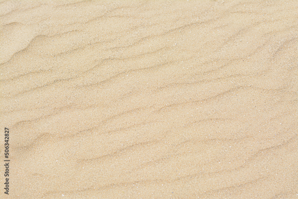 Dry beach sand with wave pattern as background Dry beach sand with wave pattern as background