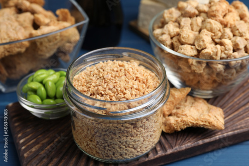Vászonkép Dehydrated soy meat and other organic products on blue table, closeup