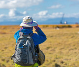 Hiking women use binoculars to travel and have a backpack.