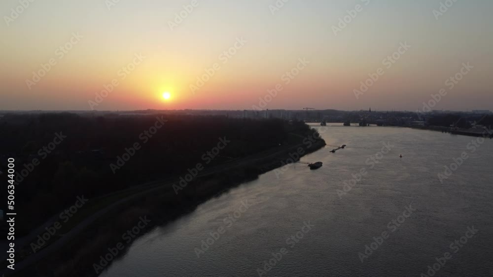 Flying Over River Schelde, Twilight View Against Sun, Late Evening Flying Over River Schelde, Twilight View Against Sun, Late Evening