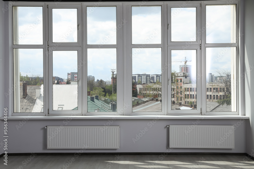 Fototapeta premium Modern office with window and radiators. Interior design