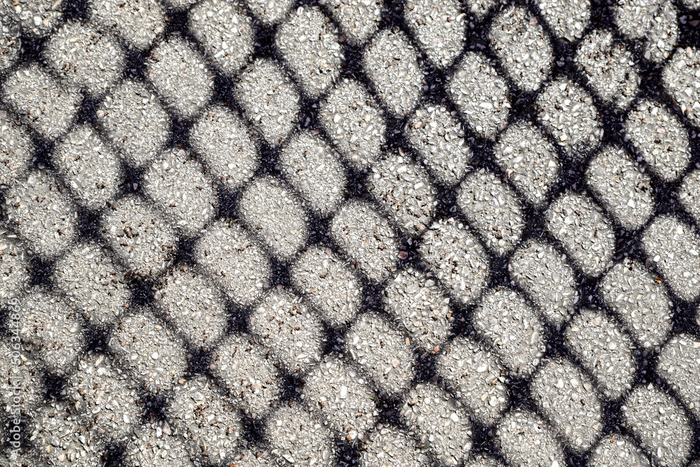 Pattern made with shadow of fence on asphalt Pattern made with shadow of fence on asphalt