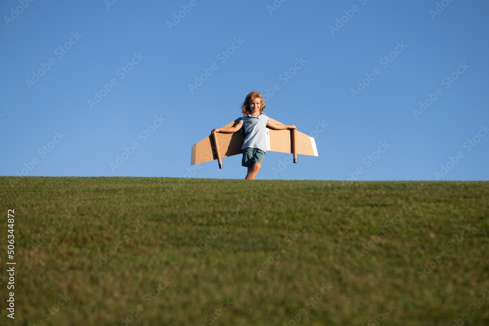 Child boy playing and dreaming about summer vacation and travel. Kids imagination and freedom concept.