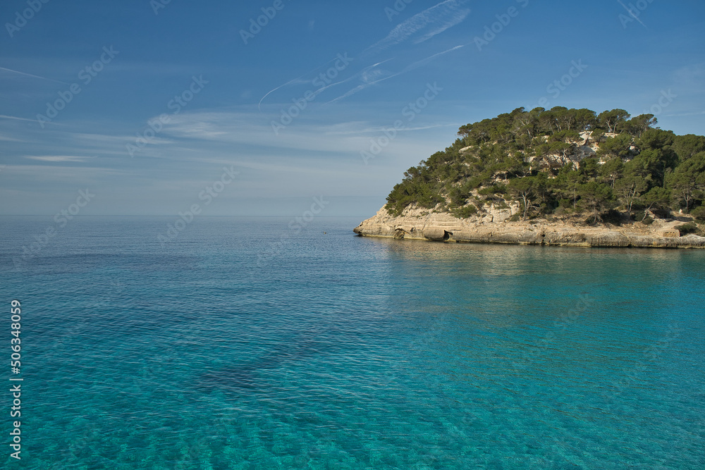Panoramic view of an island in the middle of the sea, Inspiring scene of vacation trips in nature by the sea on a sunny day with blue sky. Copy space for text.