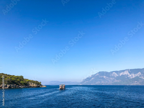 Beautiful sea view, sailboats far away in the sea in sunny day, natural background, amazing summer adventure.