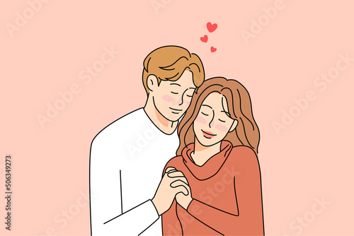 Happy young couple hug enjoy romantic connection 
