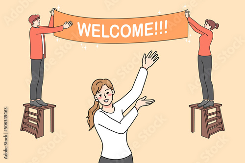 Happy people hanging Welcome banner inviting visitors to party or celebration. Smiling hosts decorating house entrance welcoming customers or passer-by. Vector illustration. 