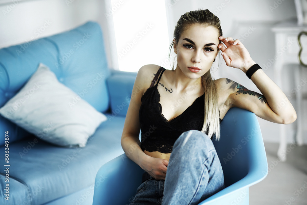 Female student in resting in the room. Young stylish girl posing in the loft. Blonde with glasses. Female student in resting in the room. Young stylish girl posing in the loft. Blonde with glasses.