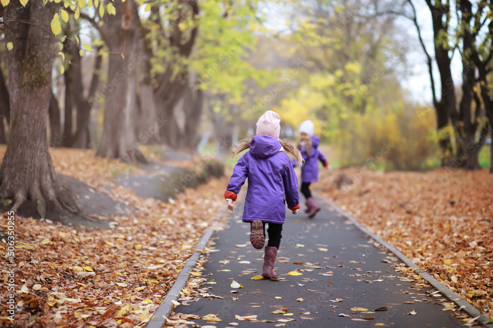 Young family on a walk in the autumn park on a sunny day. Happiness to be together. Young family on a walk in the autumn park on a sunny day. Happiness to be together.