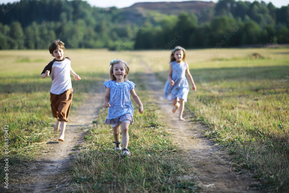 Children walk in the summer in nature. Child on a sunny spring morning in the park. Traveling with children.