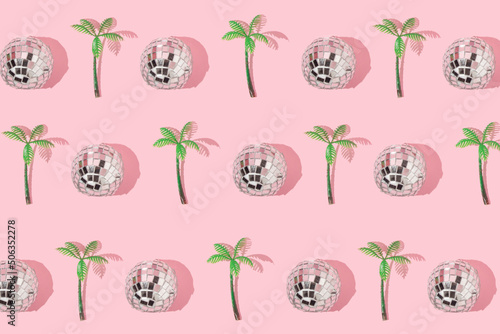 Summer creative pattern with  disco ball decoration and palm tree figurine on pastel pink background. 80s or 90s retro fashion aesthetic party concept. Minimal summer pop art idea.