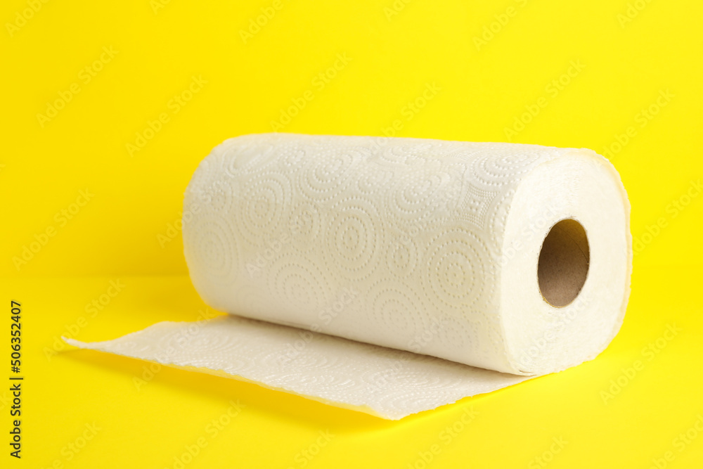 Roll of paper towels on yellow background Roll of paper towels on yellow background