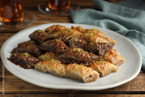 Delicious baklava with pistachios on wooden table