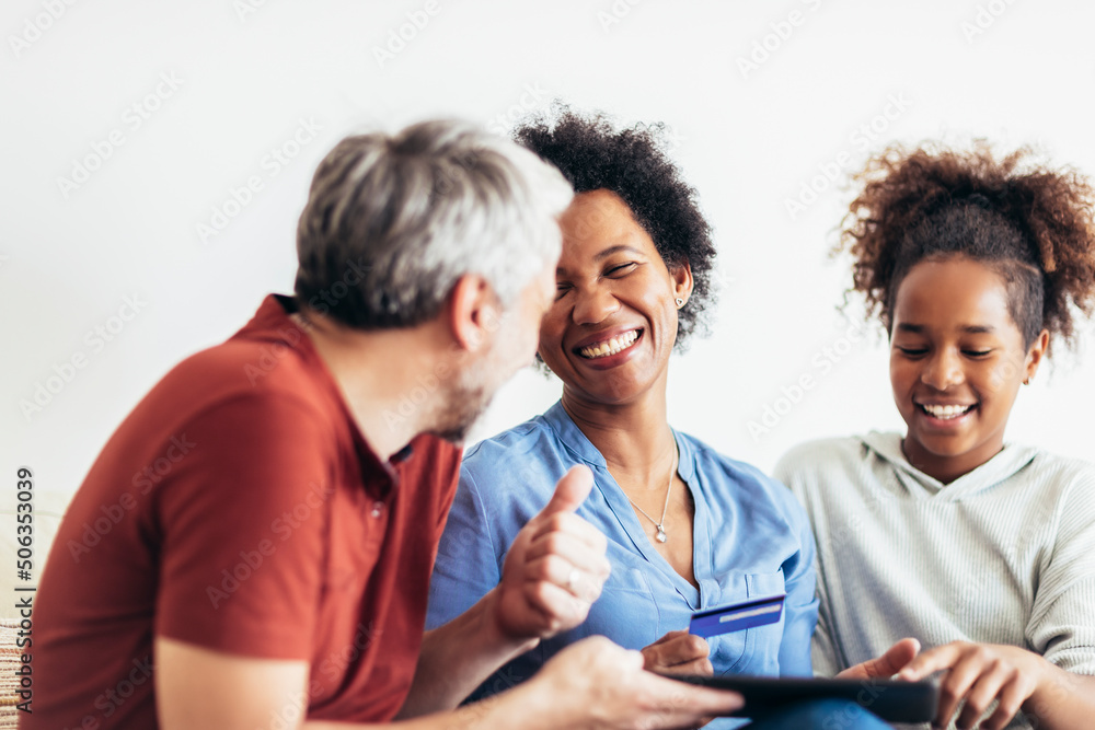 Family Using Digital Tablet And Credit Card At Home Family Using Digital Tablet And Credit Card At Home