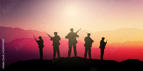 Silhouettes of soldiers standing guard in a sunset landscape