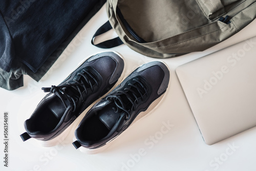 Set of men's things, flat lay top view. Sneakers, backpack, laptop on white background © shine.graphics