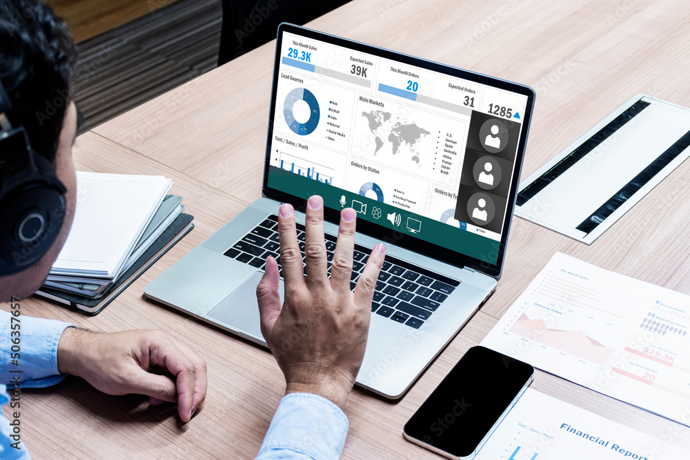Business man with headphone looking to presentation on display laptop and raise hand greeting online meeting Business man with headphone looking to presentation on display laptop and raise hand greeting online meeting