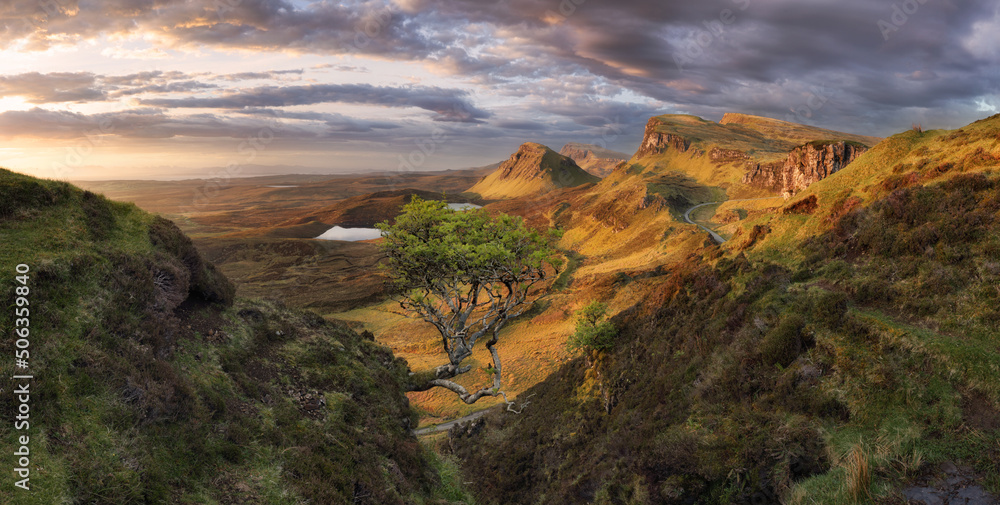 Scotland - Beautiful summer sunrise mountain landscape over the Quiraing and it's steep winding mountain road, on the Isle of Skye, UK