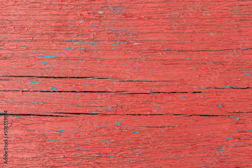 Red old wooden background with blue splashes with cracks. copy space. Place for text. Basis for