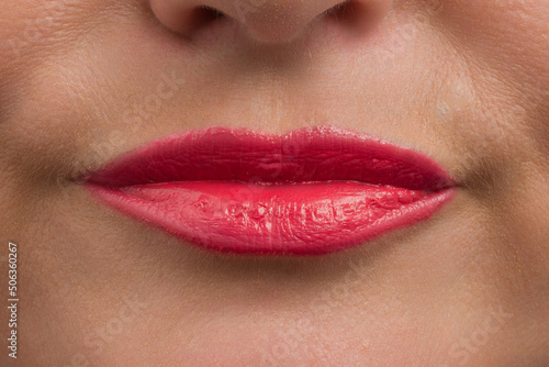 red lipstick on human lips closeup