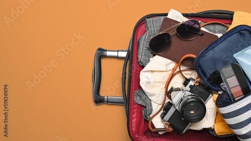 Above view suitcase full of women clothing for summer holidays. Top view with copy space
