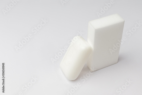 soap and melamine sponge for cleaning, white background with copy space photo