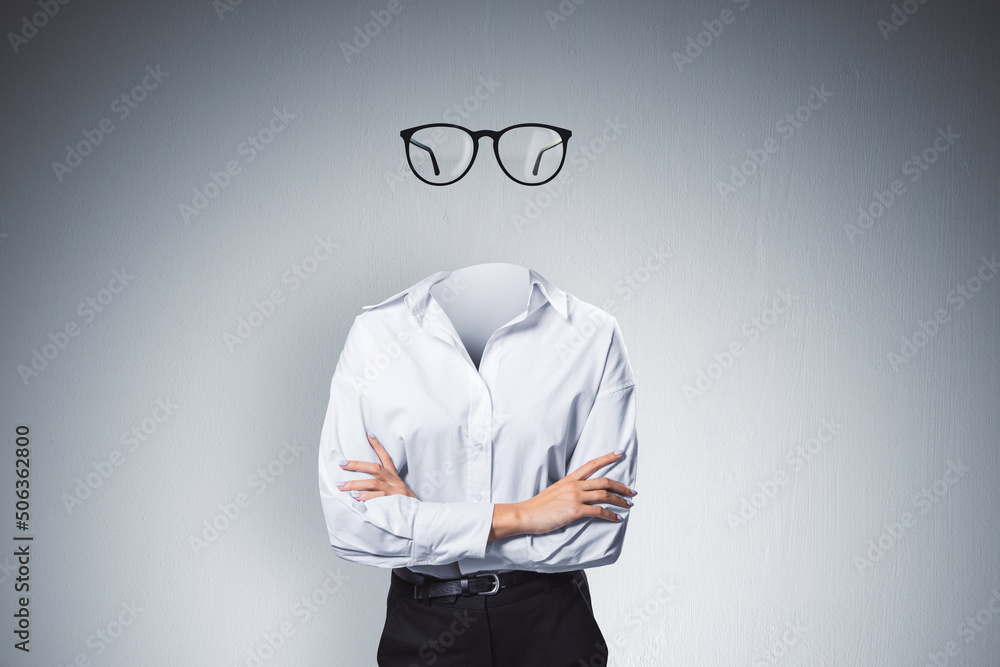 Headless invisible businesswoman with folded arms and abstract glasses standing on gray wall background. Business and secret concept. - obrazy, fototapety, plakaty 