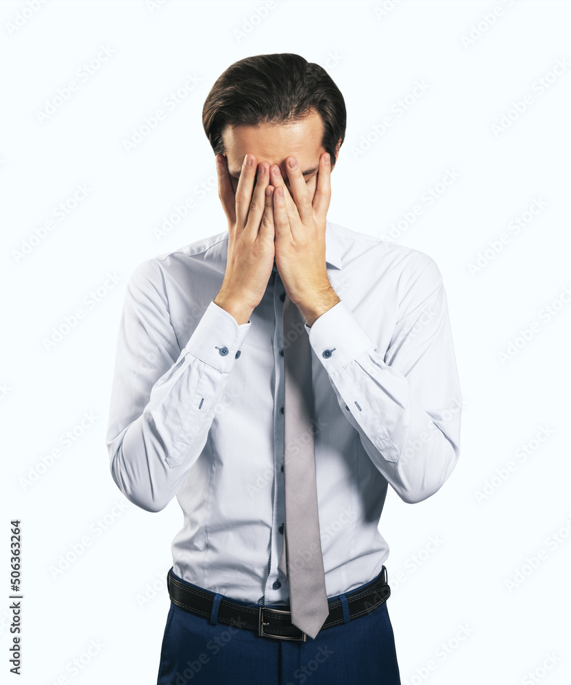Stress and find solution concept with man in white shirt closing his eyes, facepalm isolated on white background Stress and find solution concept with man in white shirt closing his eyes, facepalm isolated on white background