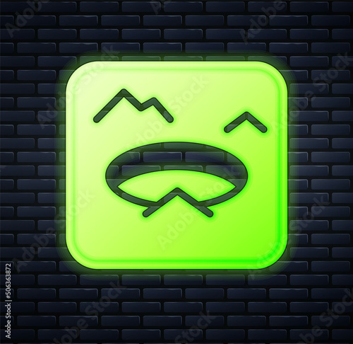 Glowing neon Winter fishing icon isolated on brick wall background. Round ice frame. Hole in ice. Vector