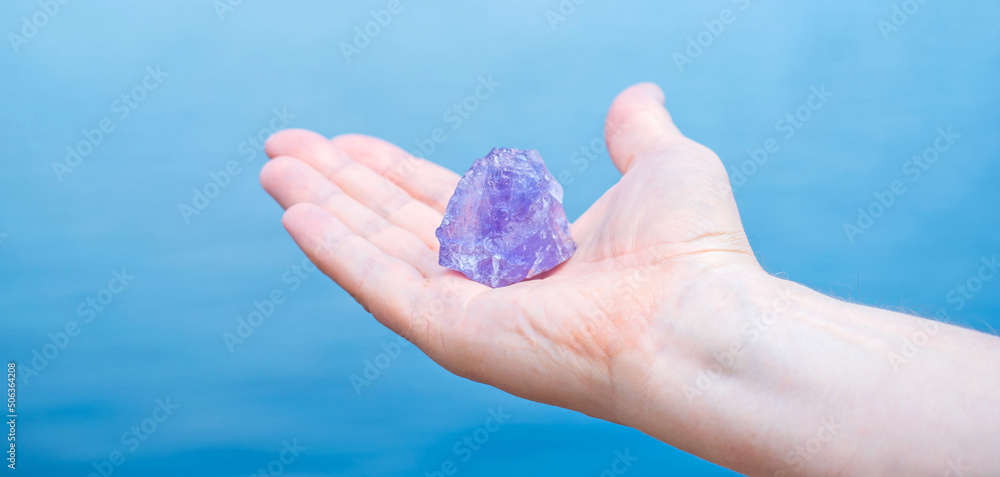 Quartz in hand, amethyst, alternative medicine. Energy therapy for mental healing Quartz in hand, amethyst, alternative medicine. Energy therapy for mental healing