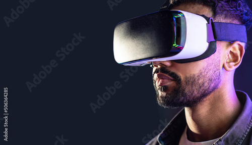 Young man using virtual reality headset, VR, future gadgets, technology, virtual event, education, learning, video game concept, Portrait of modern guy using vr glasses over black background