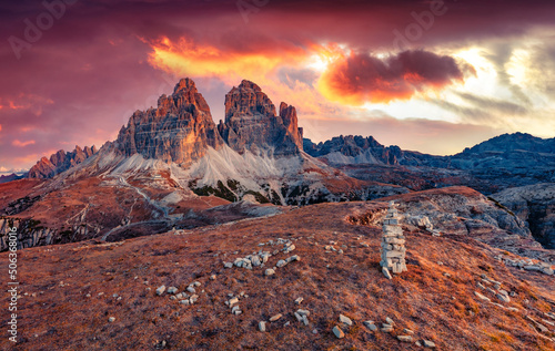 Tre Cime Di Lavaredo peaks at sunset. Dramatic autumn scene of mountain National park in Italy. Great evenig view of Dolomite Alps. Beauty of nature concept background.
