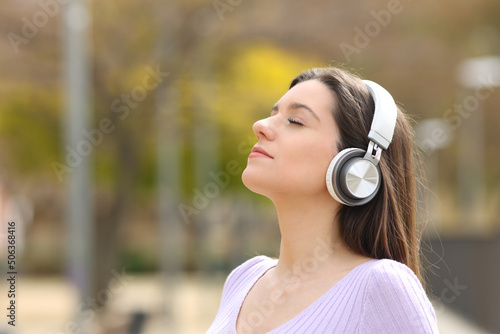 Teen meditating with headphones listening guide