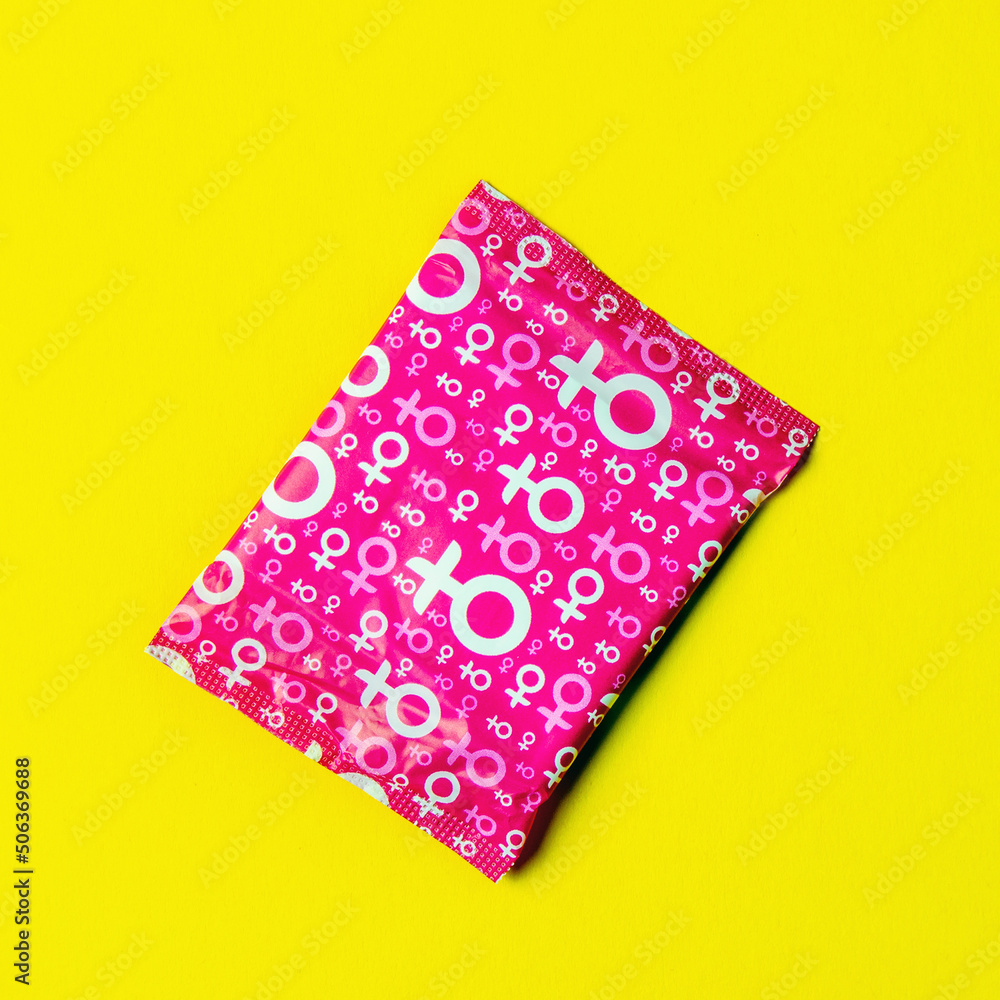 Hygienic pad in the package close-up on a yellow background. Square image. space for text placement Hygienic pad in the package close-up on a yellow background. Square image. space for text placement