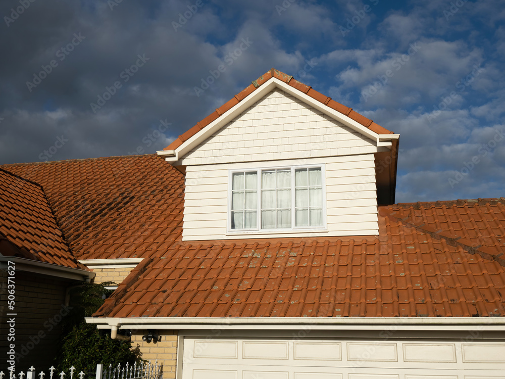 Obraz premium View of pitched roof dormer loft with window and concrete tiles