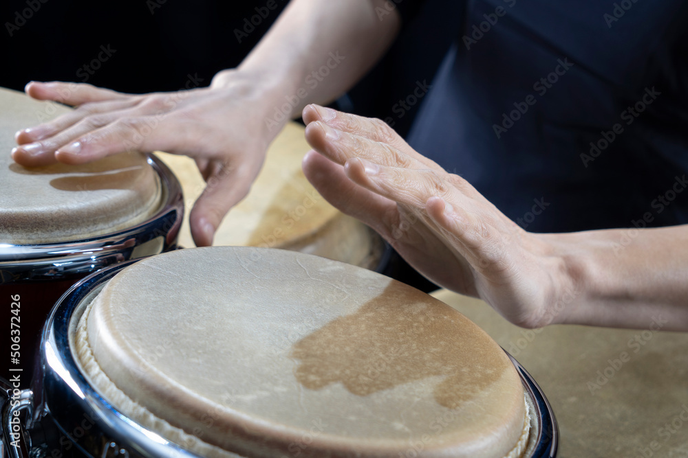 Hands of percussionist playing conga drum Hands of percussionist playing conga drum