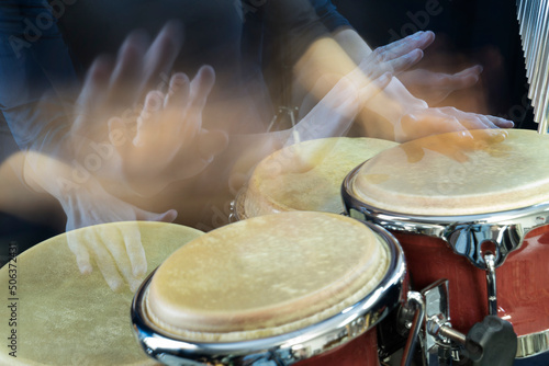 Hands of woman playing bongo photo