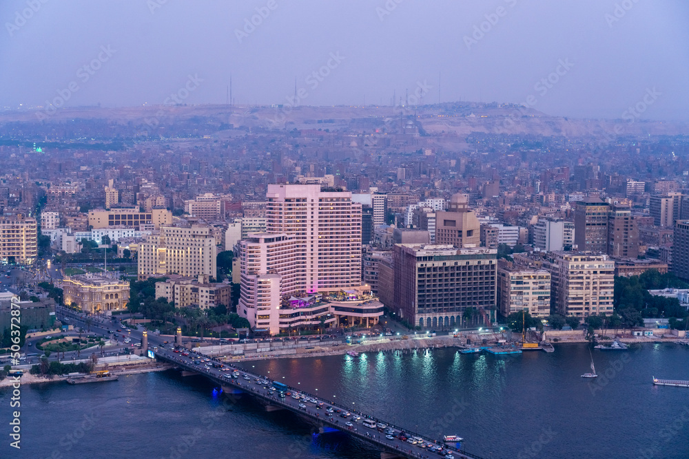 Egypt, Cairo, River Nile, Qasr El Nil Bridge and surrounding downtown buildings at dusk Egypt, Cairo, River Nile, Qasr El Nil Bridge and surrounding downtown buildings at dusk