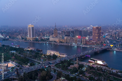 Egypt, Cairo, River Nile, Qasr El Nil Bridge and surrounding downtown buildings at dusk