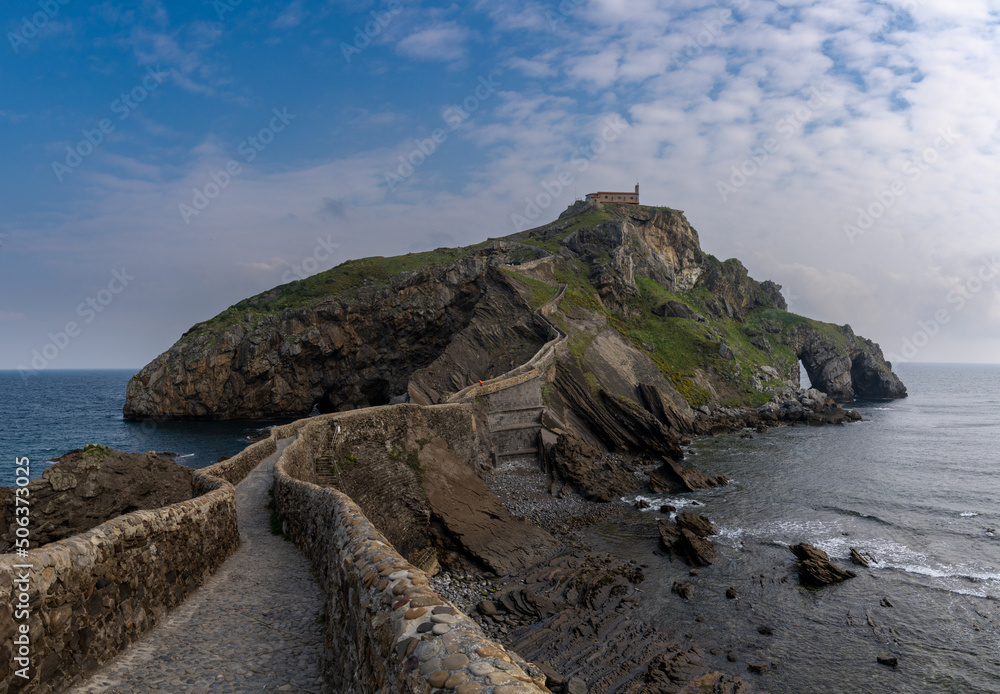 view of the church of San Juan de Gaztelugatxe and long stone stairs leading to it
