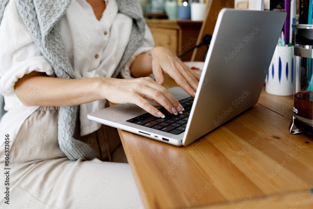 Hands of businesswoman using laptop at home Hands of businesswoman using laptop at home