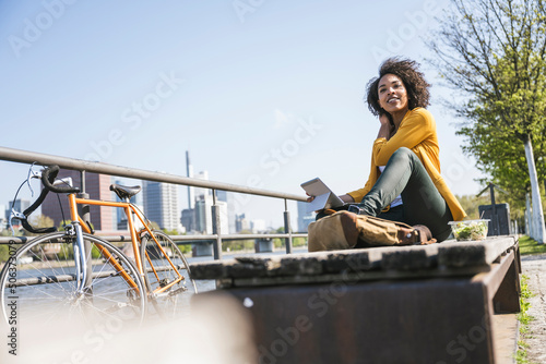 Thoughtful businesswoman sitting on bench photo