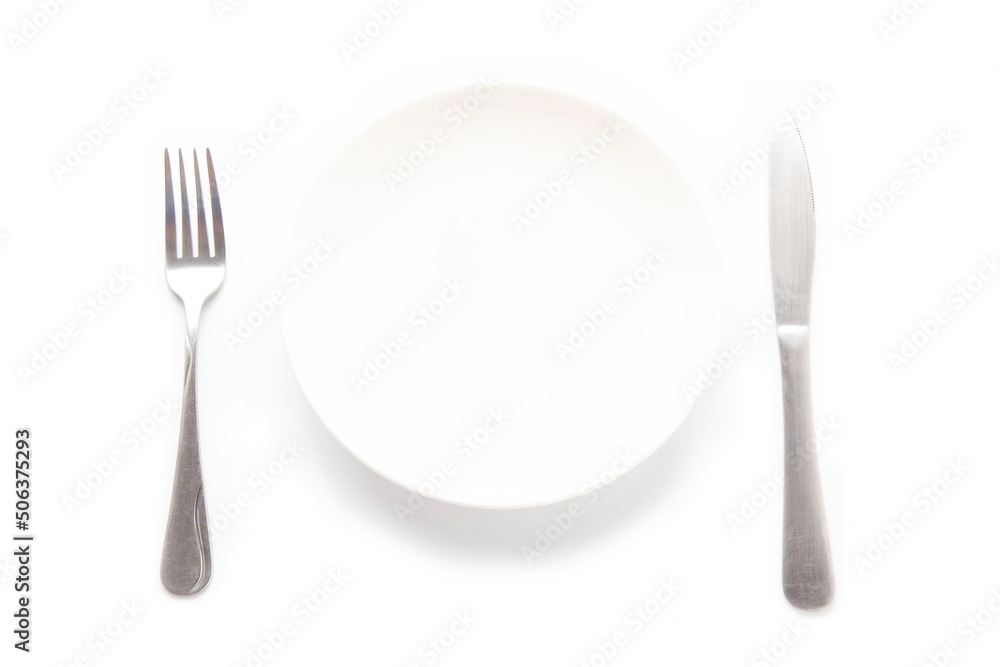 Empty white ceramic plate, knife and fork on a white table. For food, advertising space. Empty white ceramic plate, knife and fork on a white table. For food, advertising space.