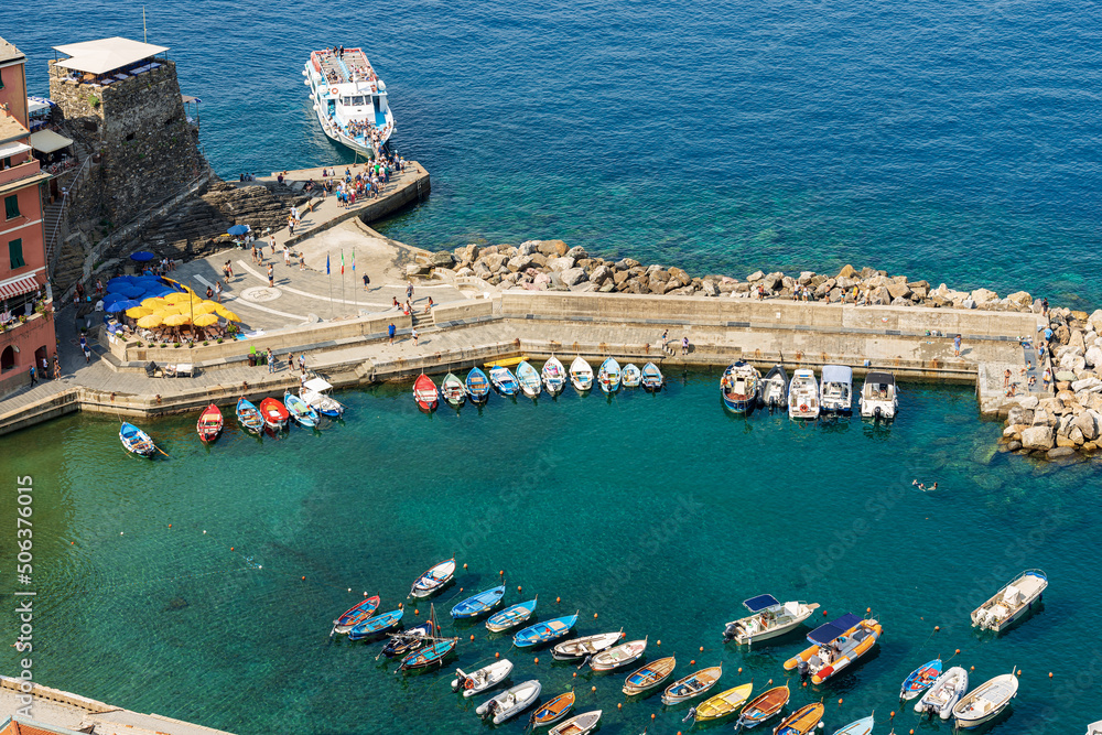 Aerial view of the small port of the ancient Vernazza village with small boats moored and the ferry station. Cinque Terre National park in Liguria, La Spezia, Italy, Europe. UNESCO world heritage site - obrazy, fototapety, plakaty 